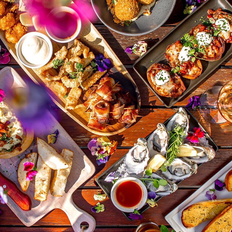 A table topped with plates of food and drinks.