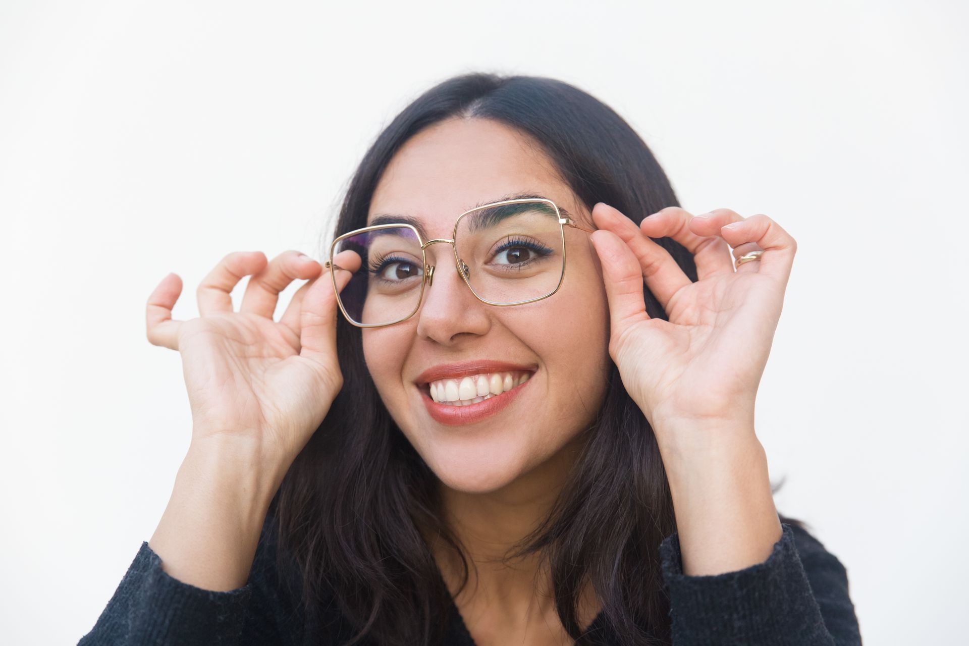 A woman is wearing glasses and smiling.