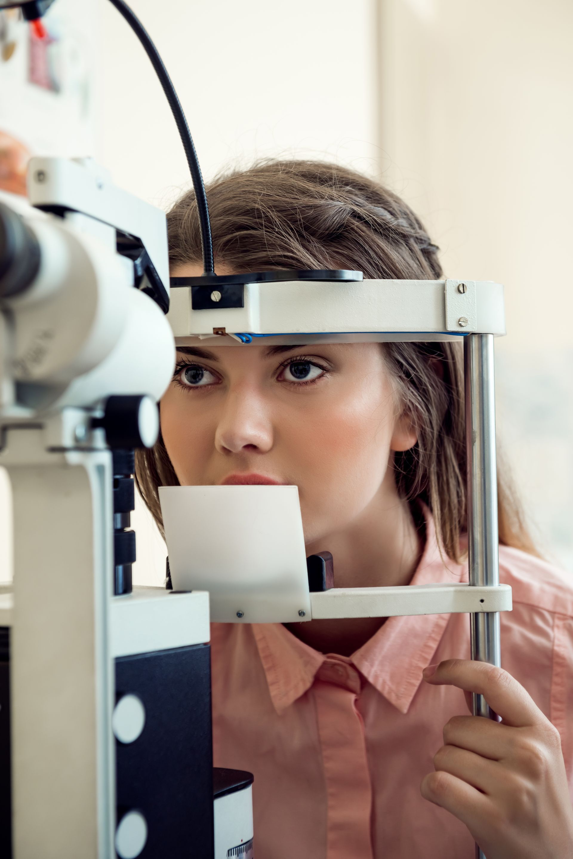 A woman is getting her eyes examined by an ophthalmologist.