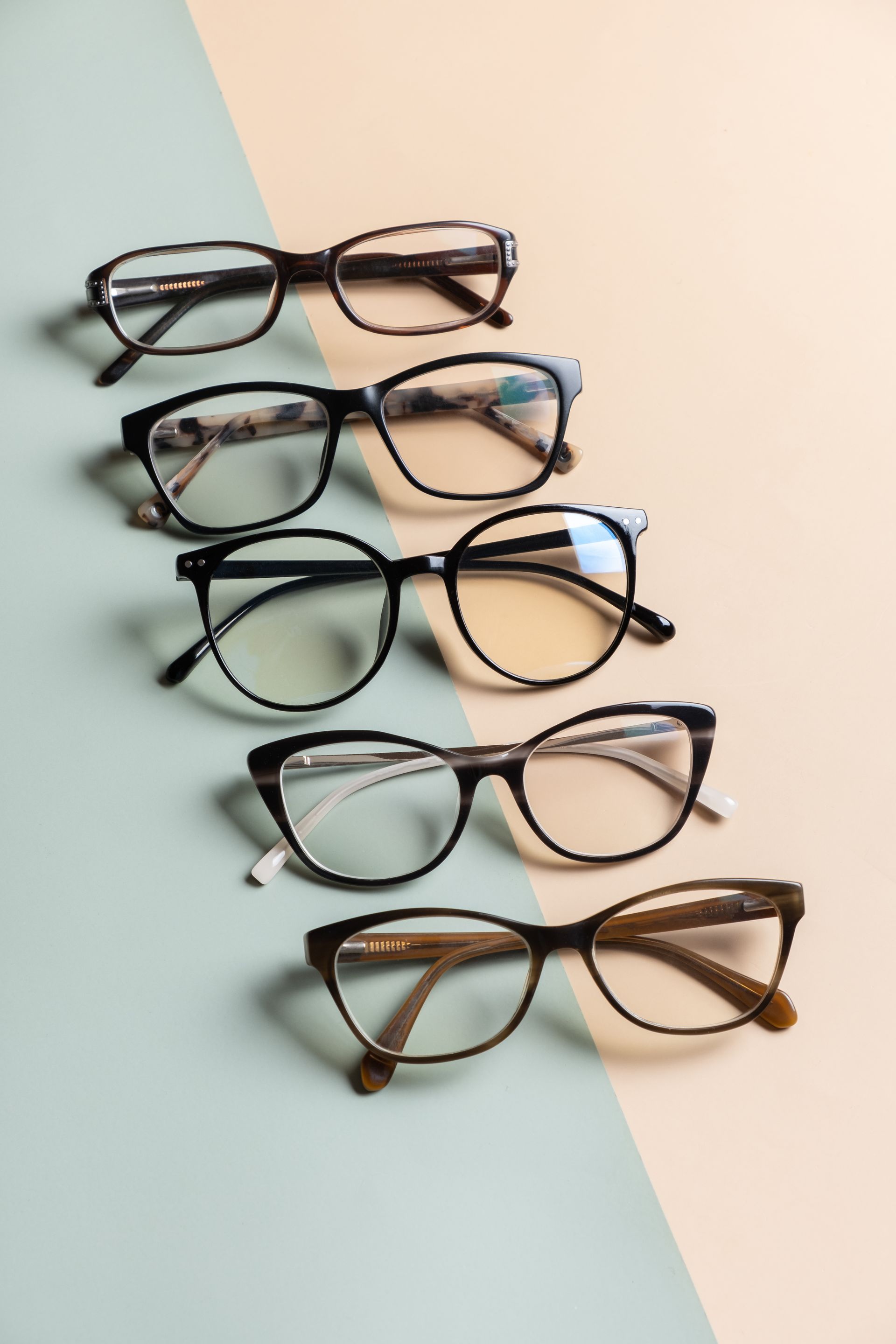 A row of glasses are lined up on a table.