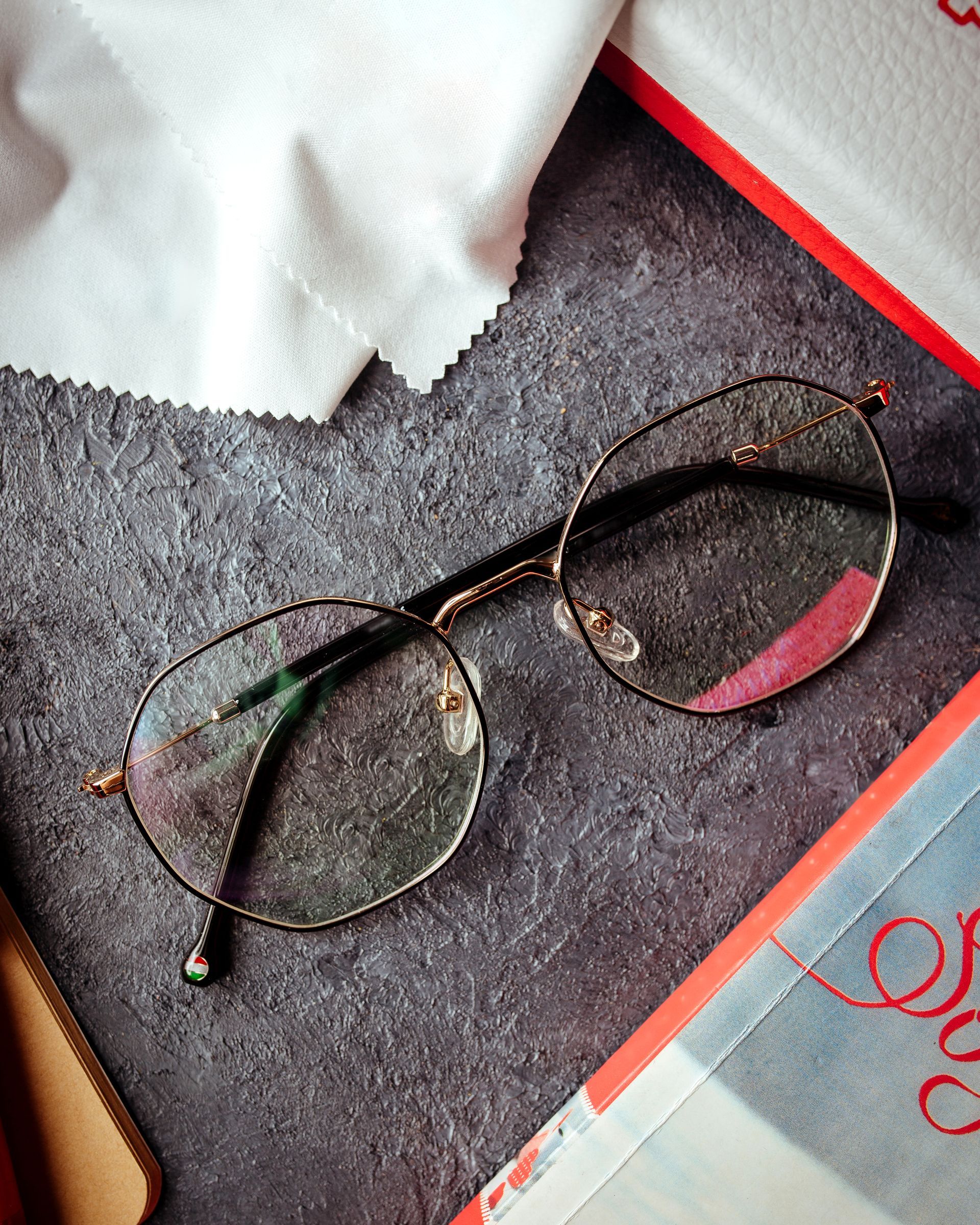 A pair of glasses is sitting on top of a book.