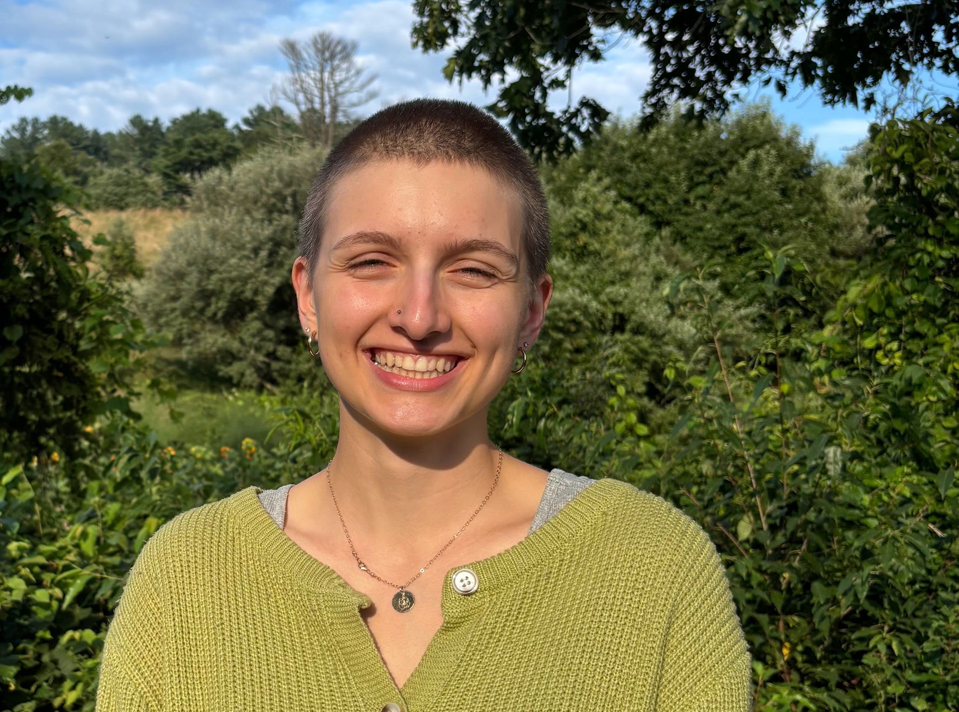 a woman is holding a potted plant in front of a sign that says `` take over '' .