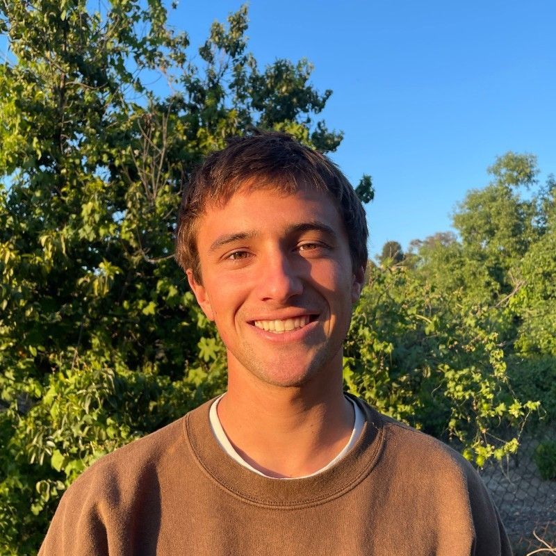 a woman is holding a potted plant in front of a sign that says `` take over '' .