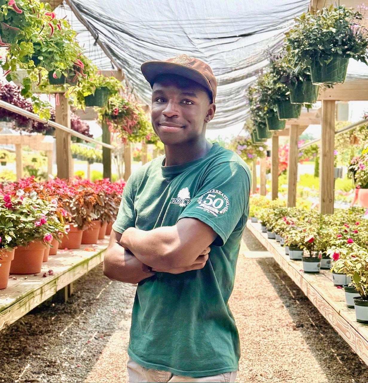 a woman is holding a potted plant in front of a sign that says `` take over '' .