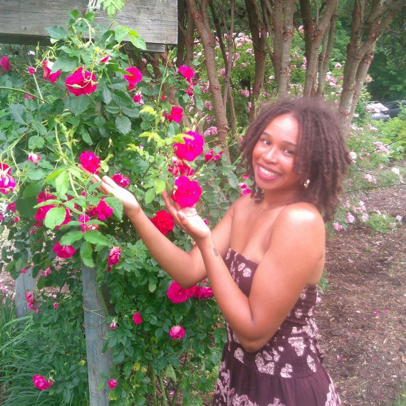 a woman is holding a potted plant in front of a sign that says `` take over '' .