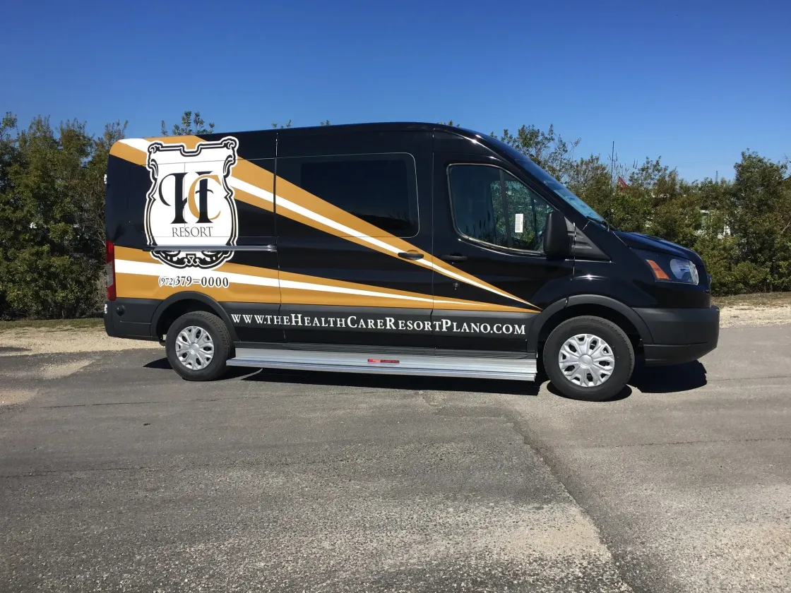 A black and gold van is parked in a parking lot.