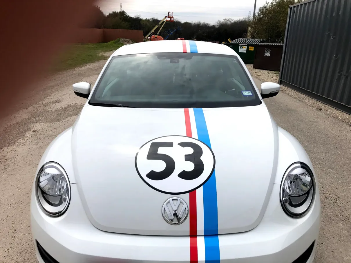 A white car with the number 53 on the hood