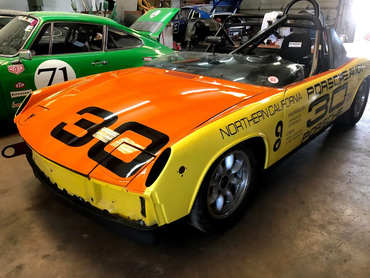 A yellow and orange race car with the number 30 on it