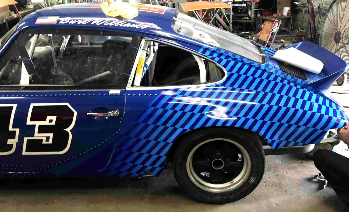 A blue race car with the number 13 on it