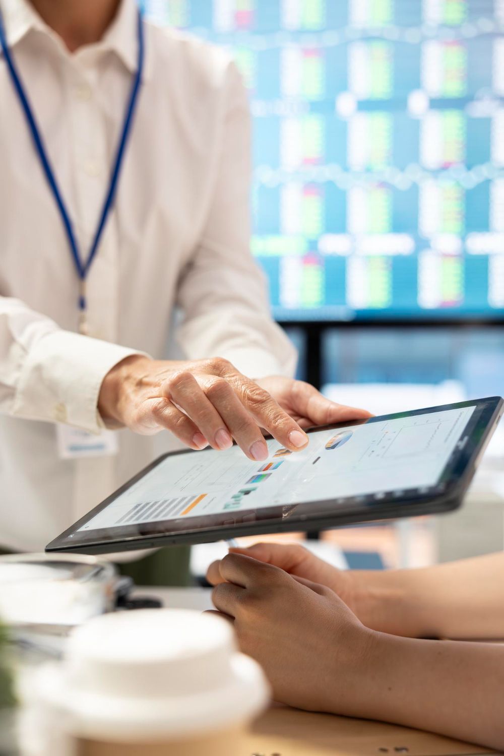 A woman is sitting at a desk using a laptop computer.