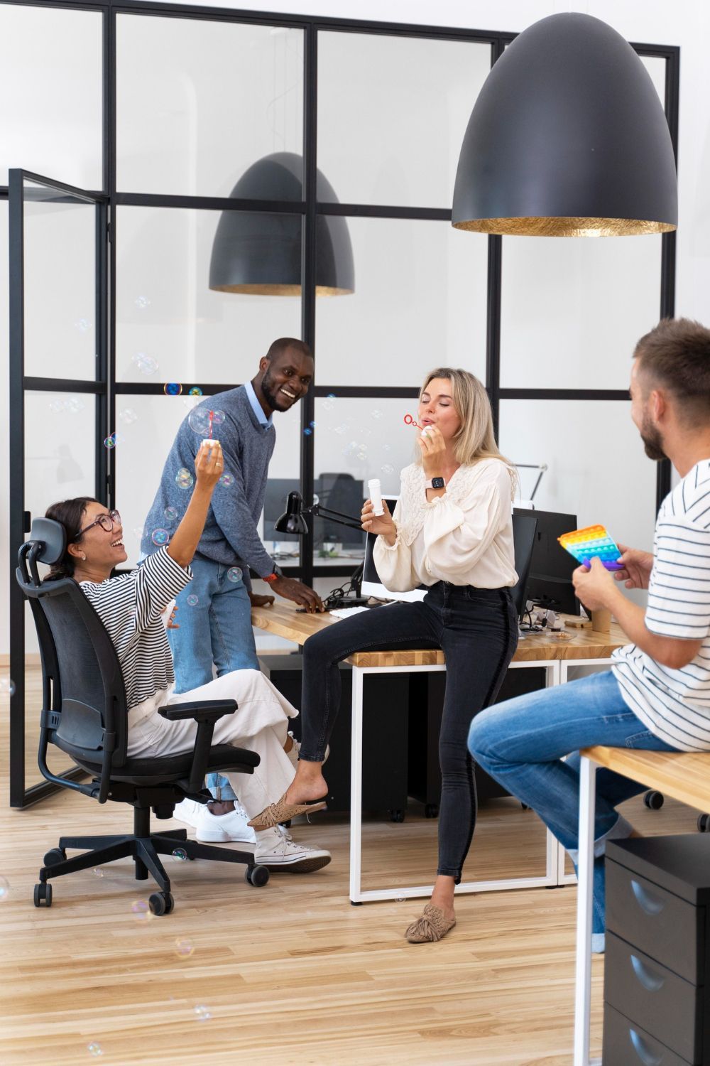 A woman is sitting at a desk using a laptop computer.