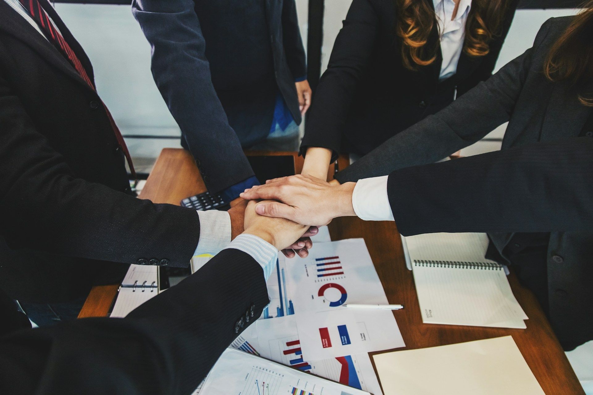 A woman is giving a presentation to a group of people in a conference room.