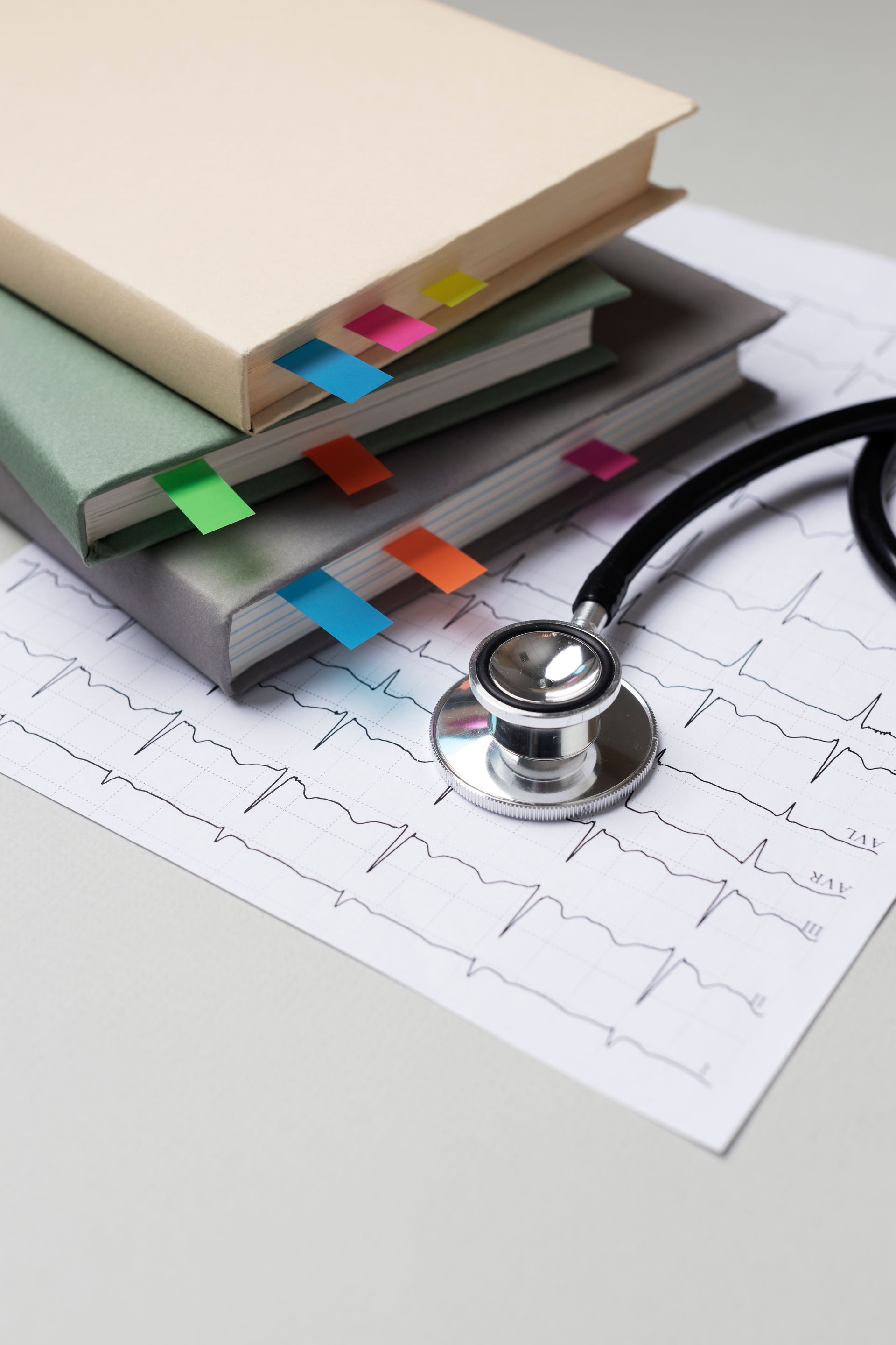 A stethoscope is sitting on top of a stack of books