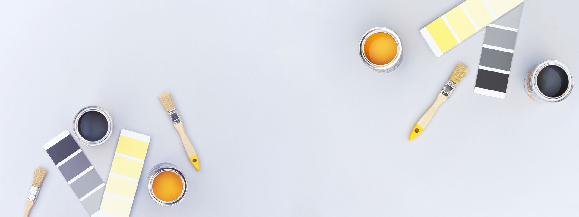 There are many different types of paint and brushes on the table.