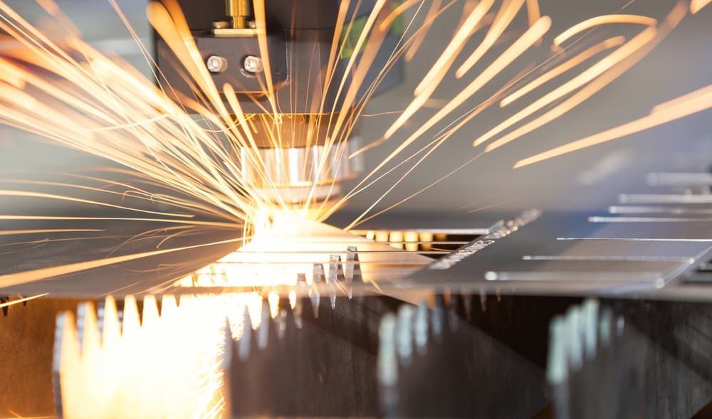 Machine Is Cutting A Piece Of Metal With Sparks Coming Out Of It — Aliweld Fabrications In Kawana, QLD