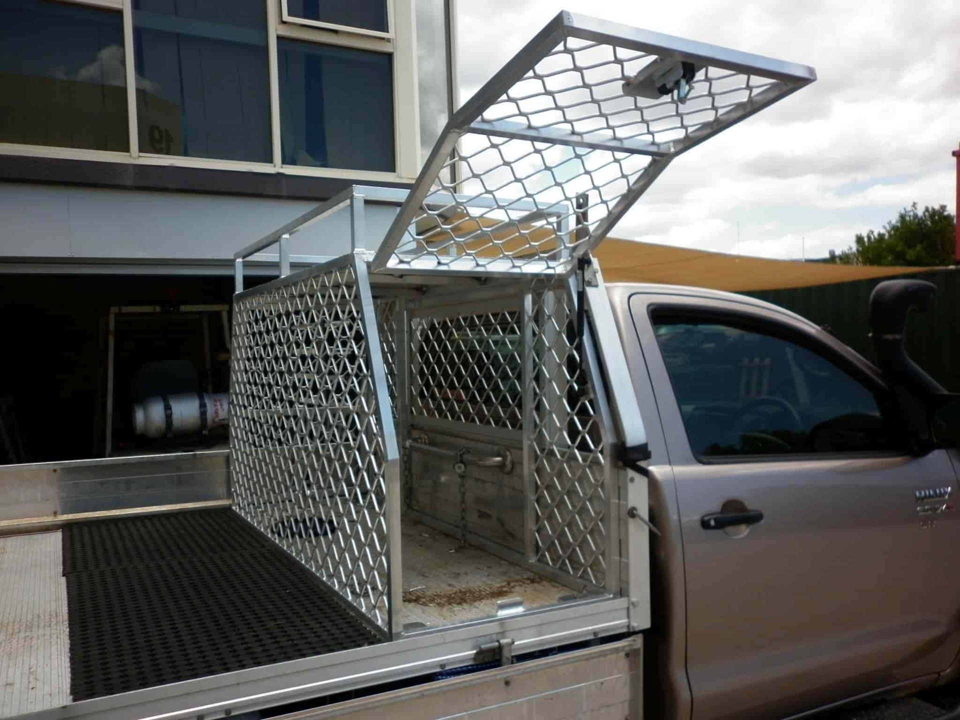 A Truck With a Cage in the Back of It — Aliweld Fabrications In Sunshine Coast, QLD