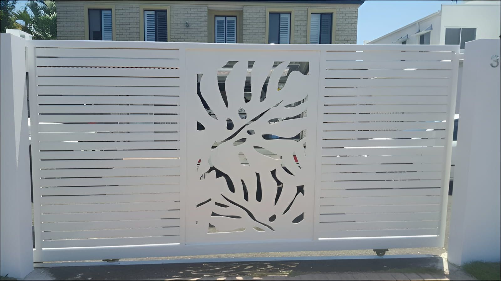 A White Fence With A Leaf Design On It — Aliweld Fabrications In Caloundra West, QLD