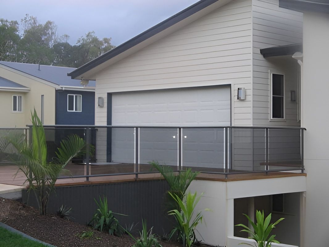 A House With A Balcony And A Garage Door — Aliweld Fabrications In Caloundra West, QLD