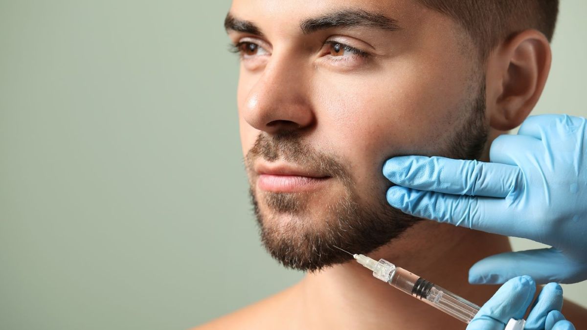 Man receives a botox shot in his jaw for TMJ pain