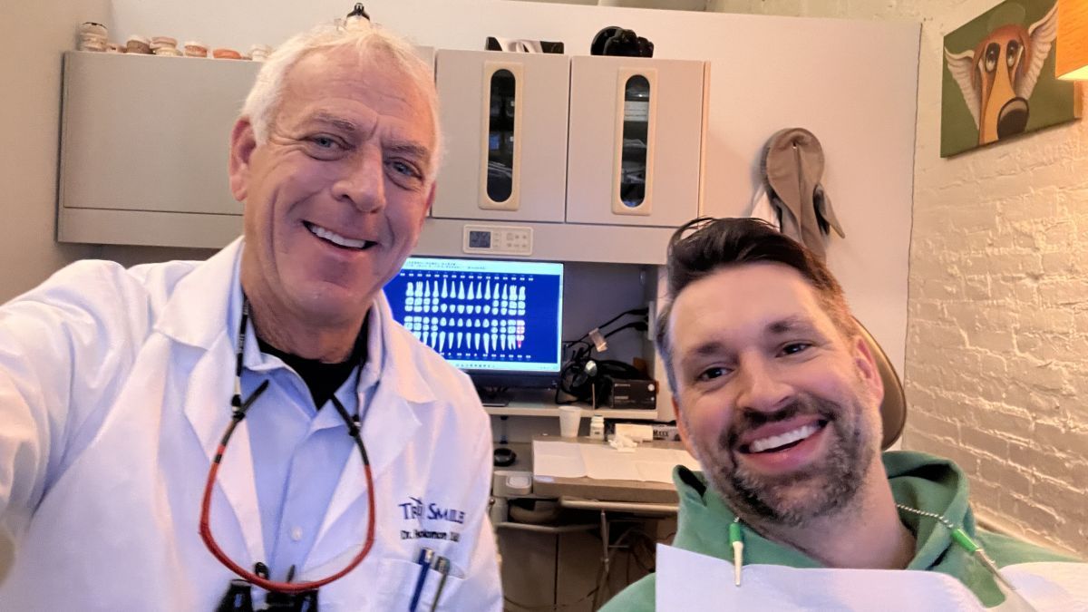 Dr. Frederick Solomon and a patients smile for a selfie