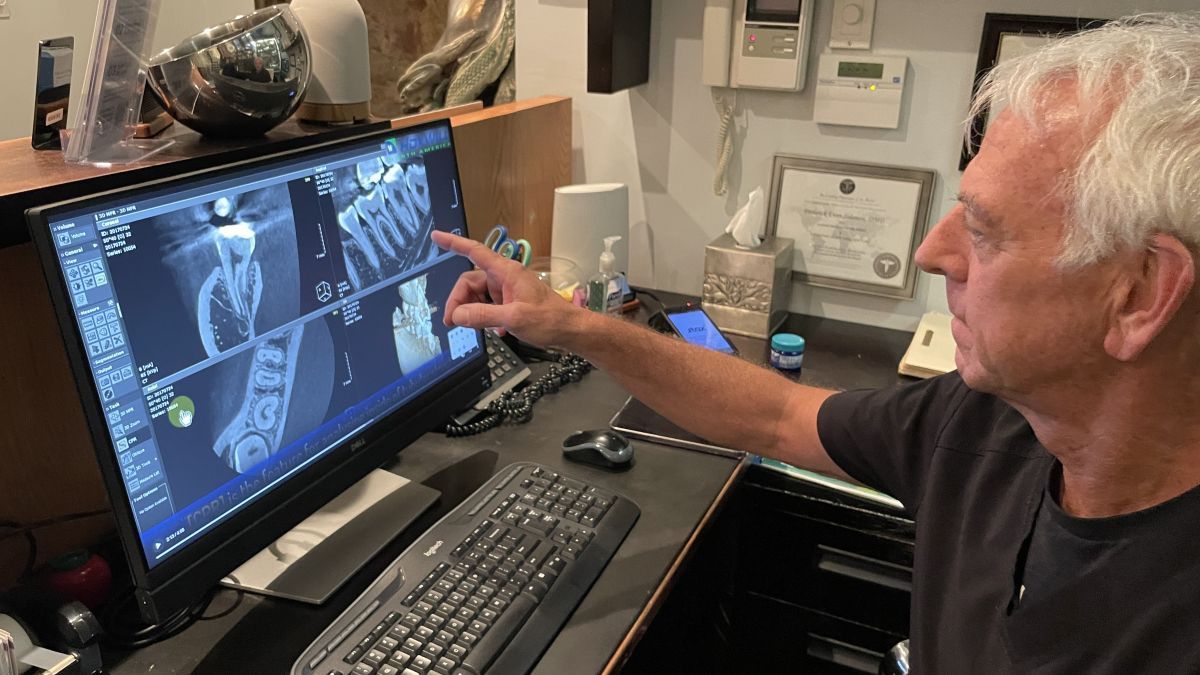 Dr. Frederick Solomon looks at a 3d scan of teeth at Tribeca Smiles practice in NYC