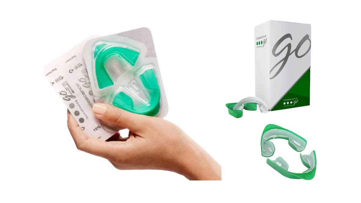A hand holding Opalescence Go prefilled teeth whitening trays with packaging and multiple tray views, showing an at-home dental whitening product.