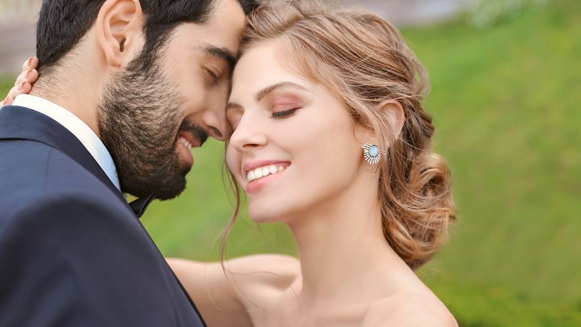 Newlywed couple at their wedding smiling 
