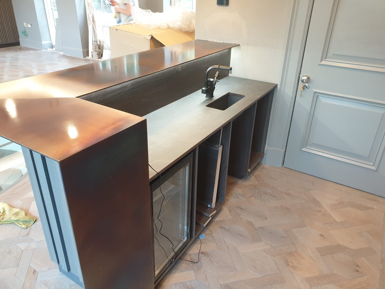 A kitchen with a stainless steel counter top and a sink.