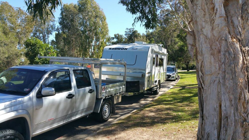 A Truck is Towing a Trailer Down a Dirt Road — Smart Automotive Technologies in Noosaville, QLD