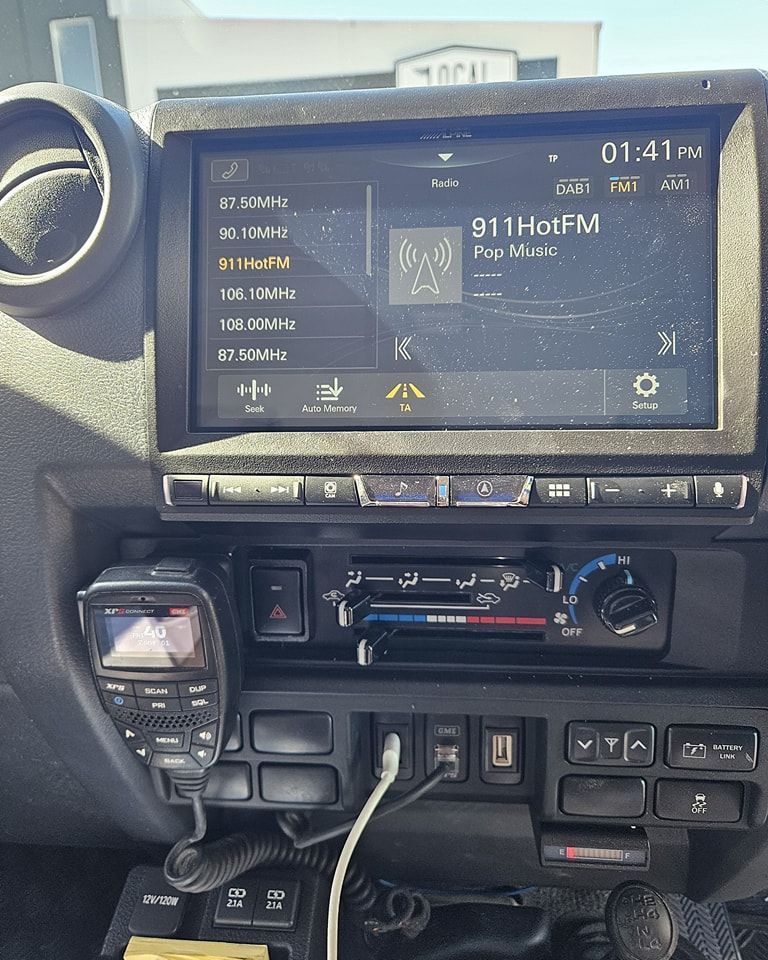 Dashboard of A Vehicle Showing a Radio Screen Playing — Smart Automotive Technologies in Noosaville, QLD