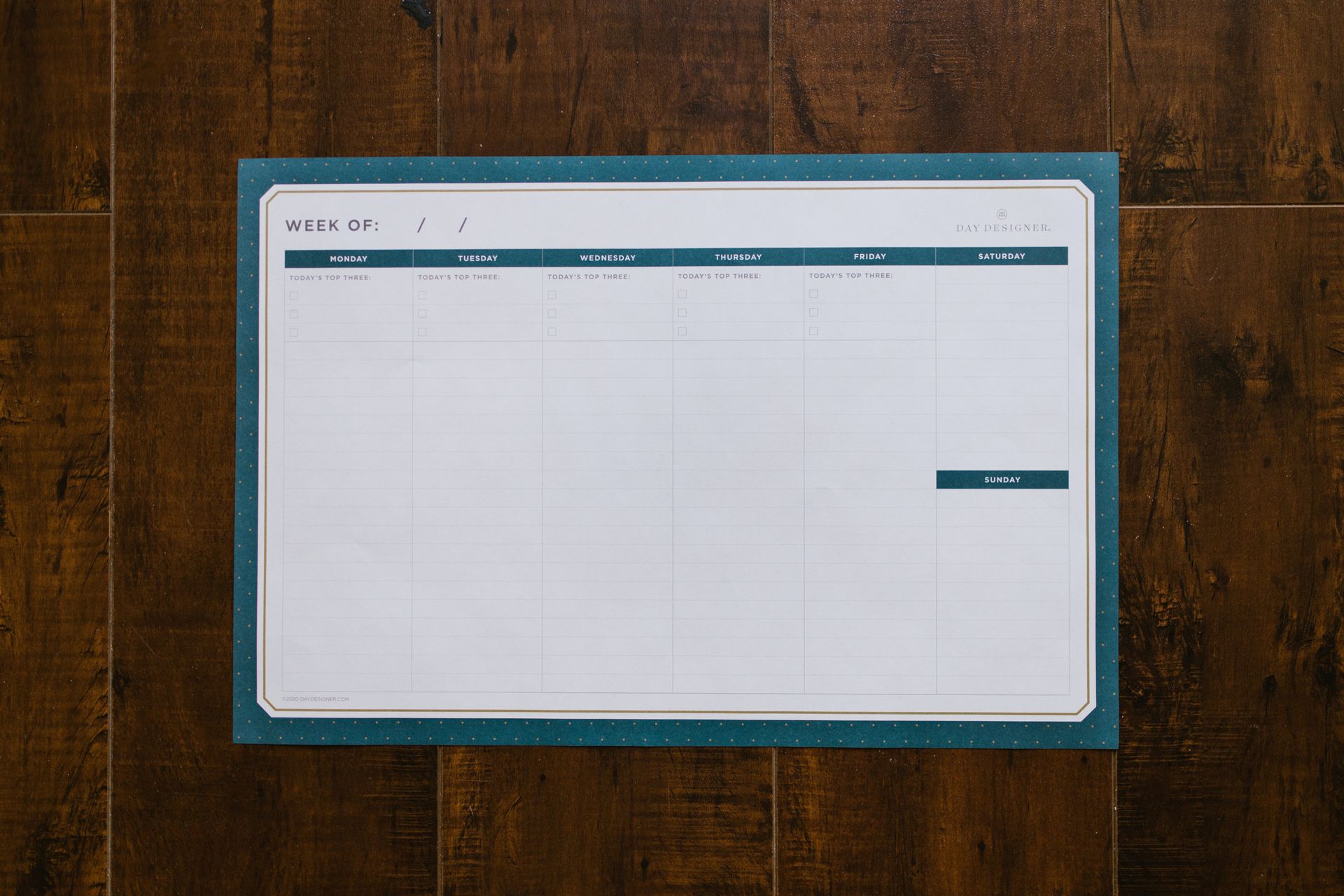 a calendar is sitting on a wooden table .