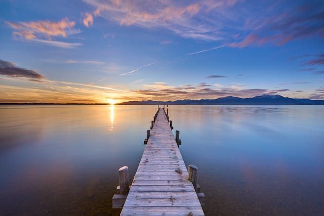 A lakeside dock stretching toward the horizon creates a calm scene for funeral homes Harvey, LA