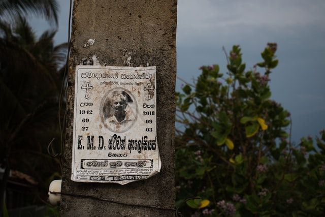 a concrete pole with a sticker on it that says e.m.d.