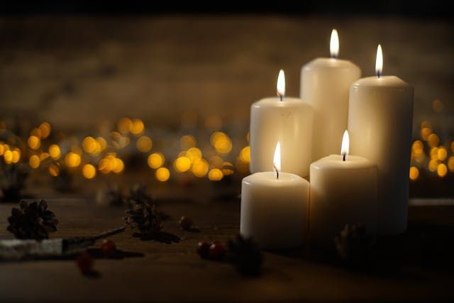 Glowing white candles with warm lights create a comforting scene for cremation services Harvey, LA