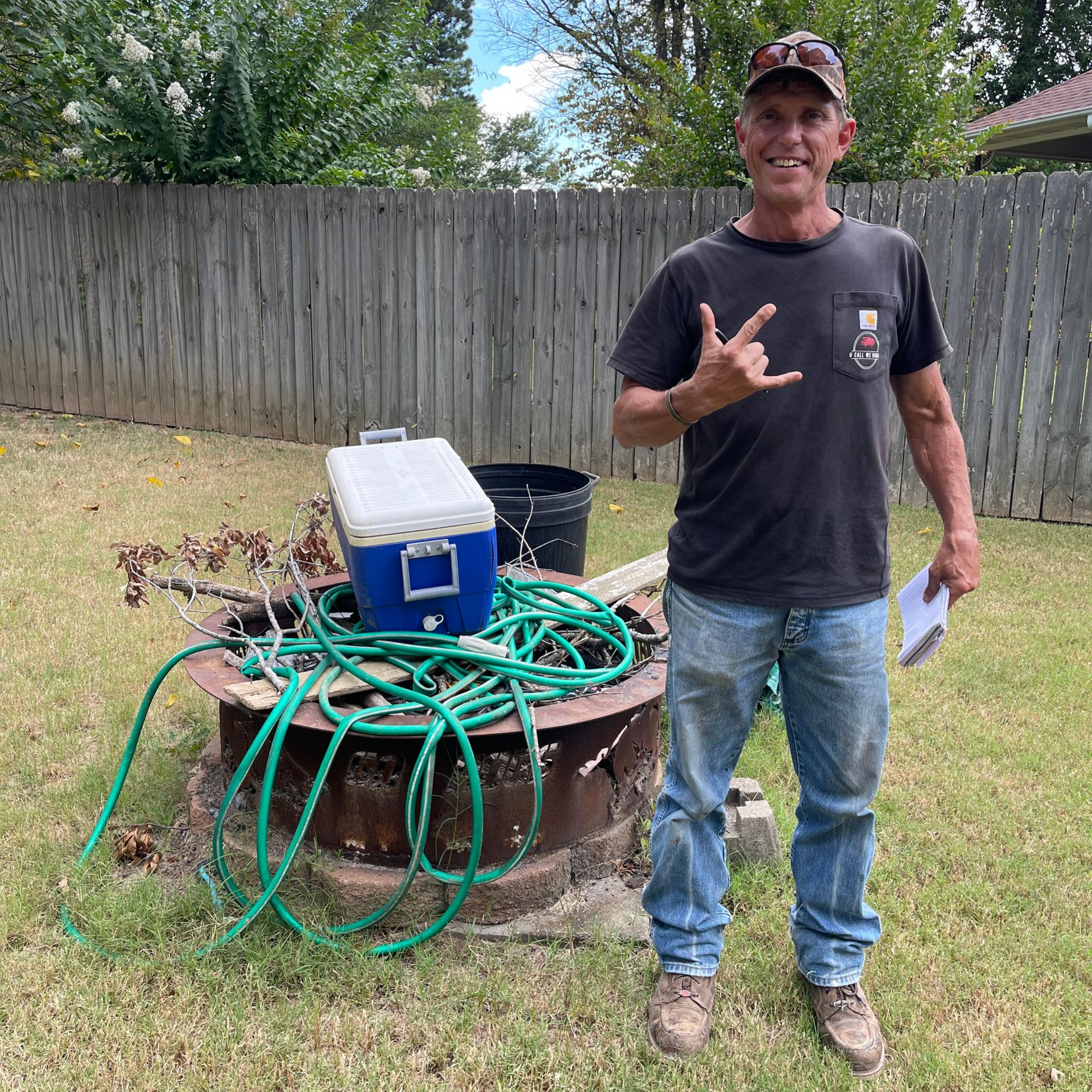 Man standing in a backyard, giving the