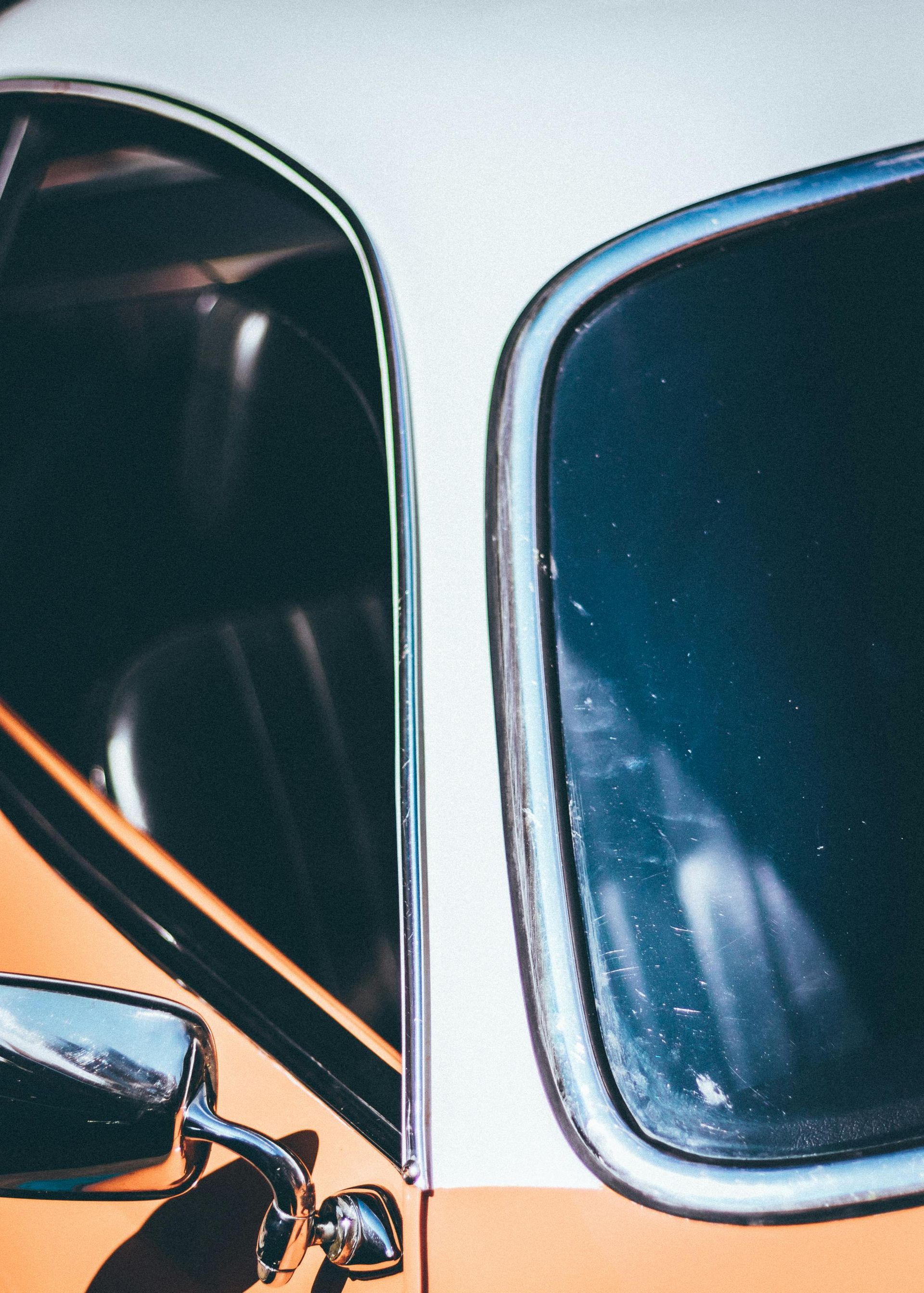 A close up of a car 's side mirror and window