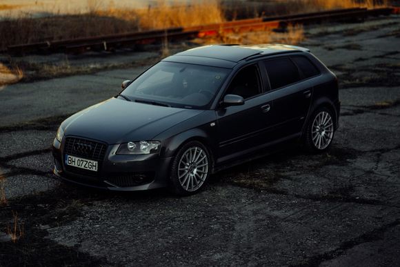 Autopage & Glass A black audi a3 is parked on the side of the road.