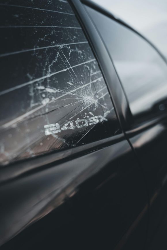 A close up of a car with a broken side window