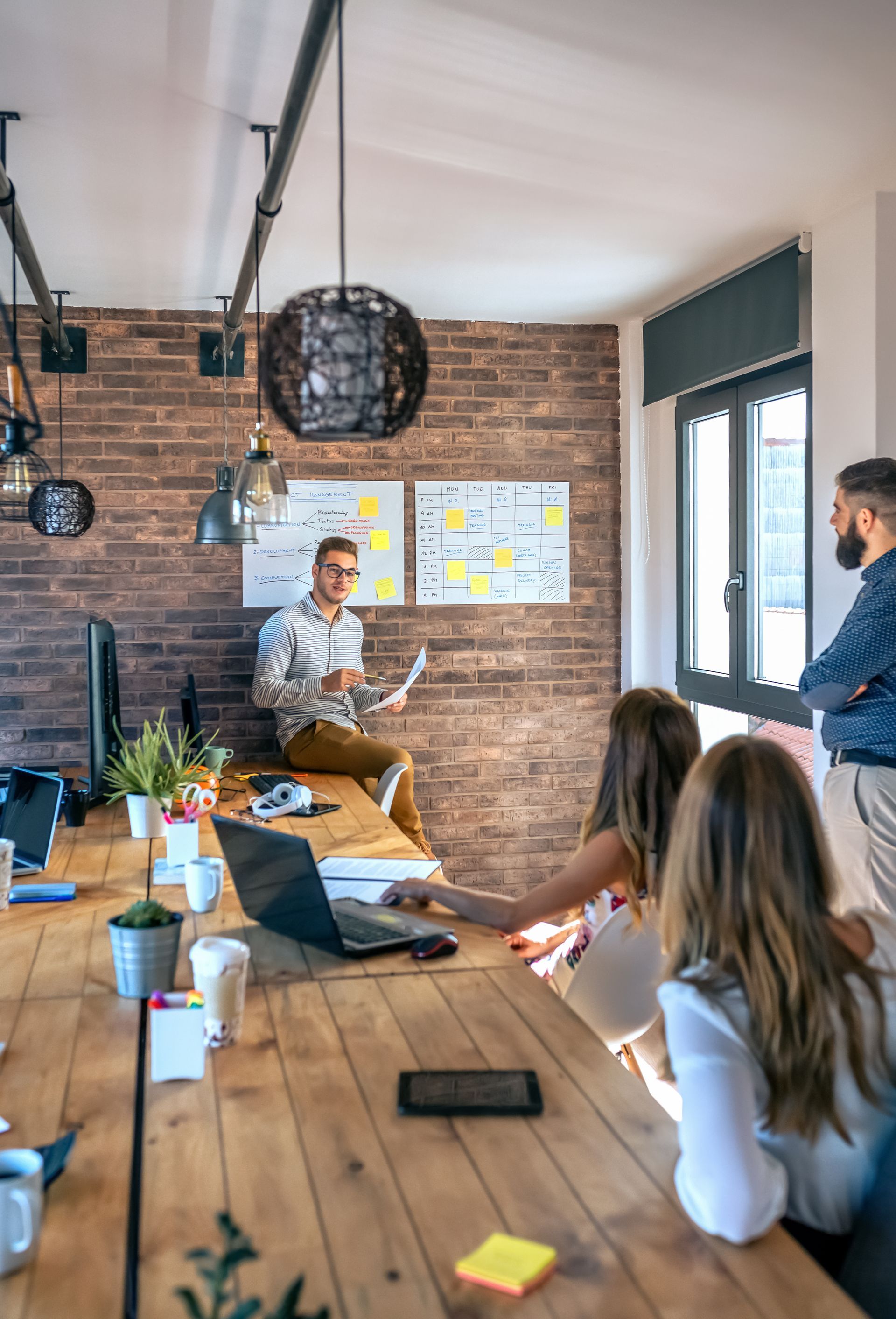 A group of people are looking at a computer screen in an office.