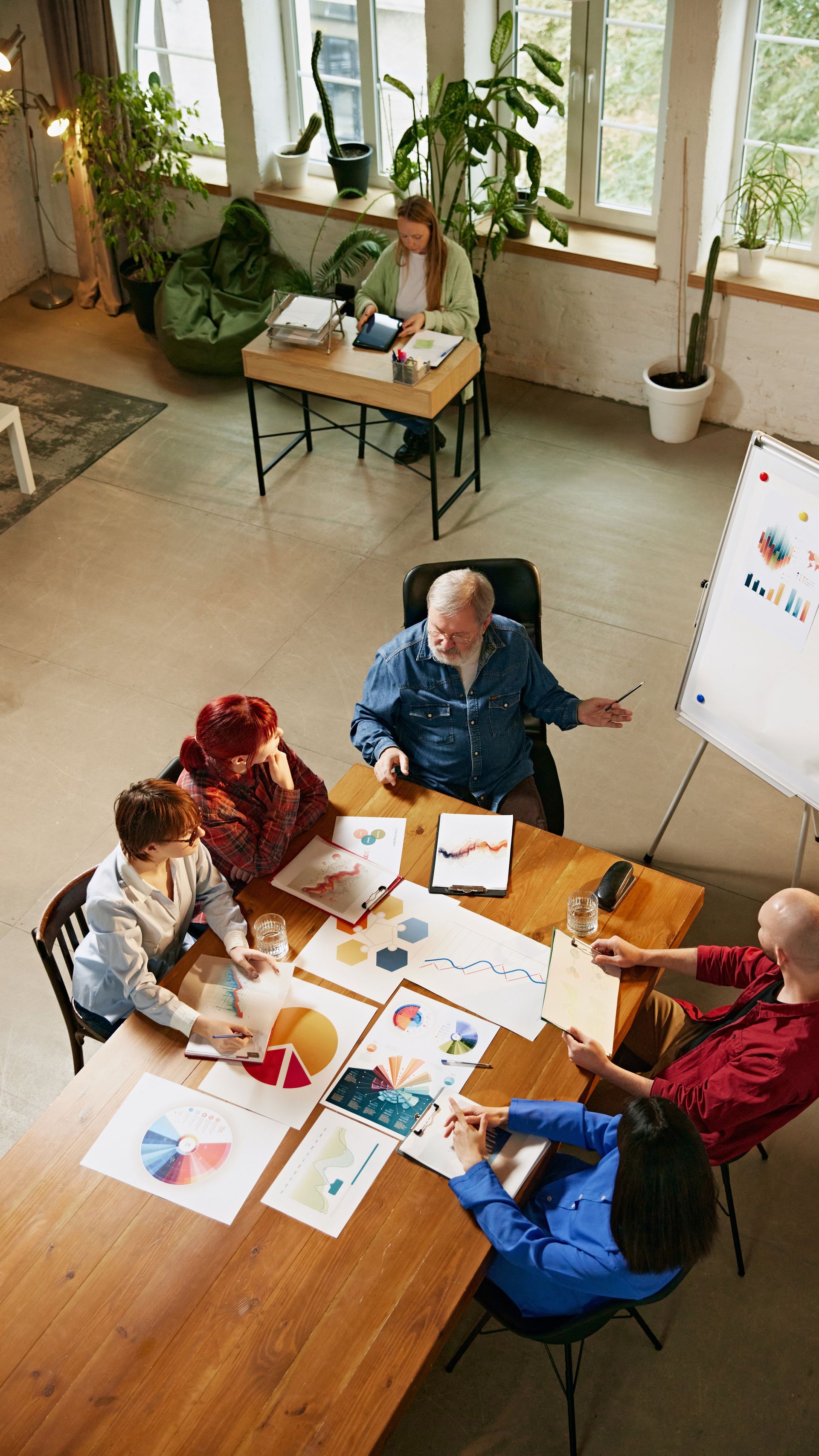 A group of people are looking at a computer screen in an office.