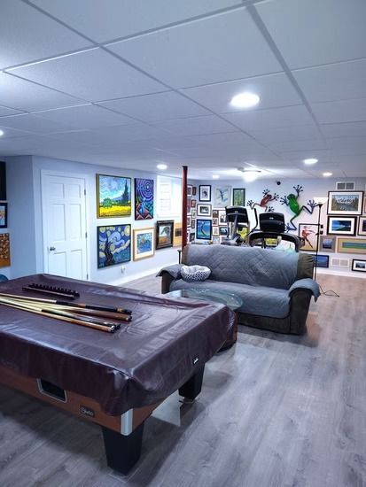A basement recreation room featuring a pool table.