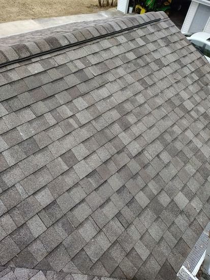 A high-angle view of a gray, textured asphalt shingle roof.