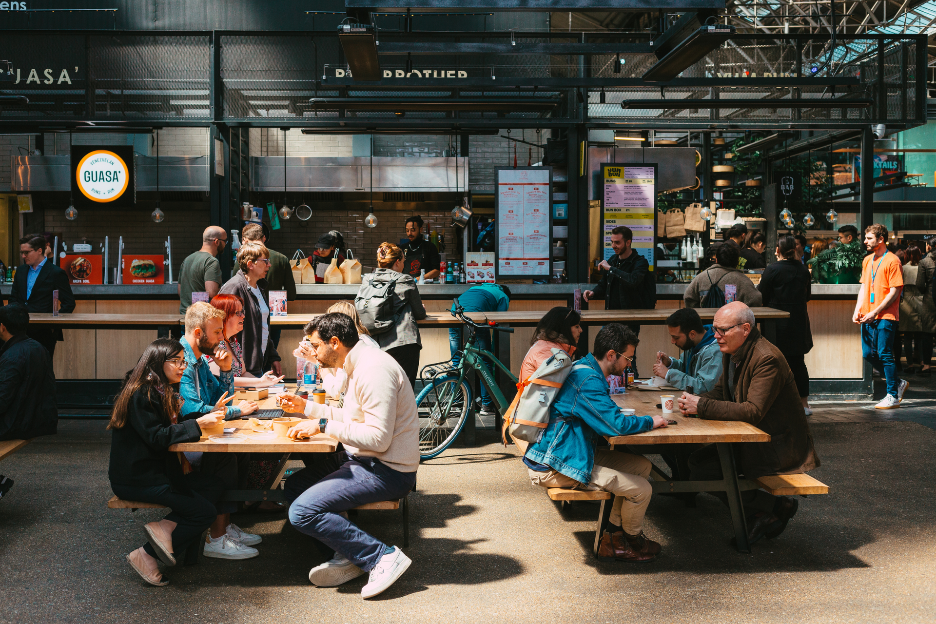 Busy Metro Market with people eating and working at tables.