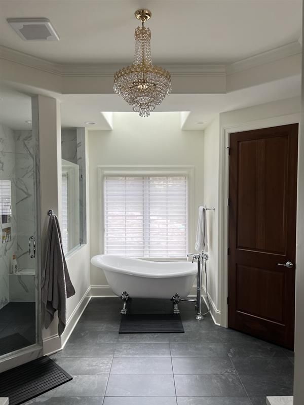 A window with white curtains and a view of trees