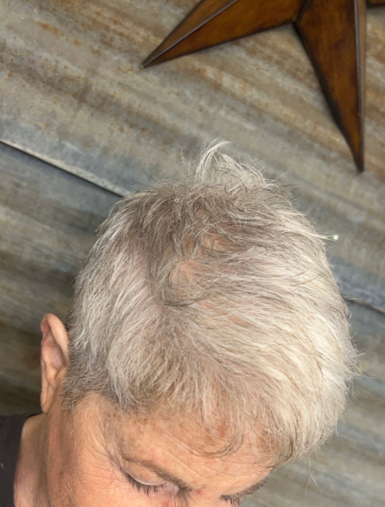 A close up of a woman 's hair with a star in the background.