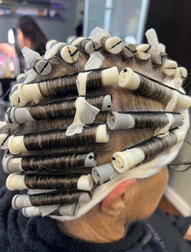 A person with a bunch of curlers in their hair