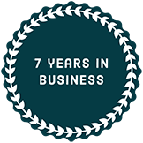 A circle with the words `` 7 years in business '' written inside of it.