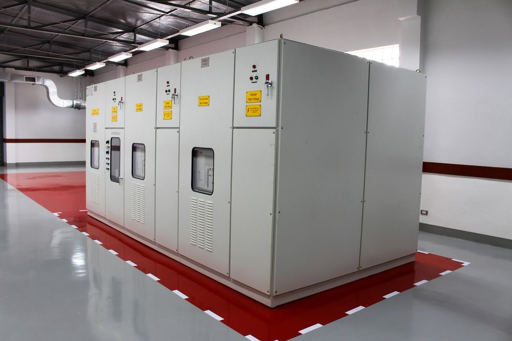A Row of White Electrical Cabinets in a Room With a Red Floor — Bangalow Electrical in Bangalow, NSW