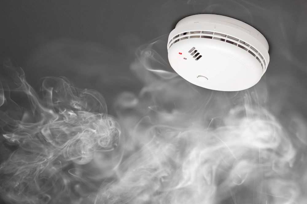 A Smoke Detector is Surrounded by Smoke Coming Out of It — Bangalow Electrical in Bangalow, NSW