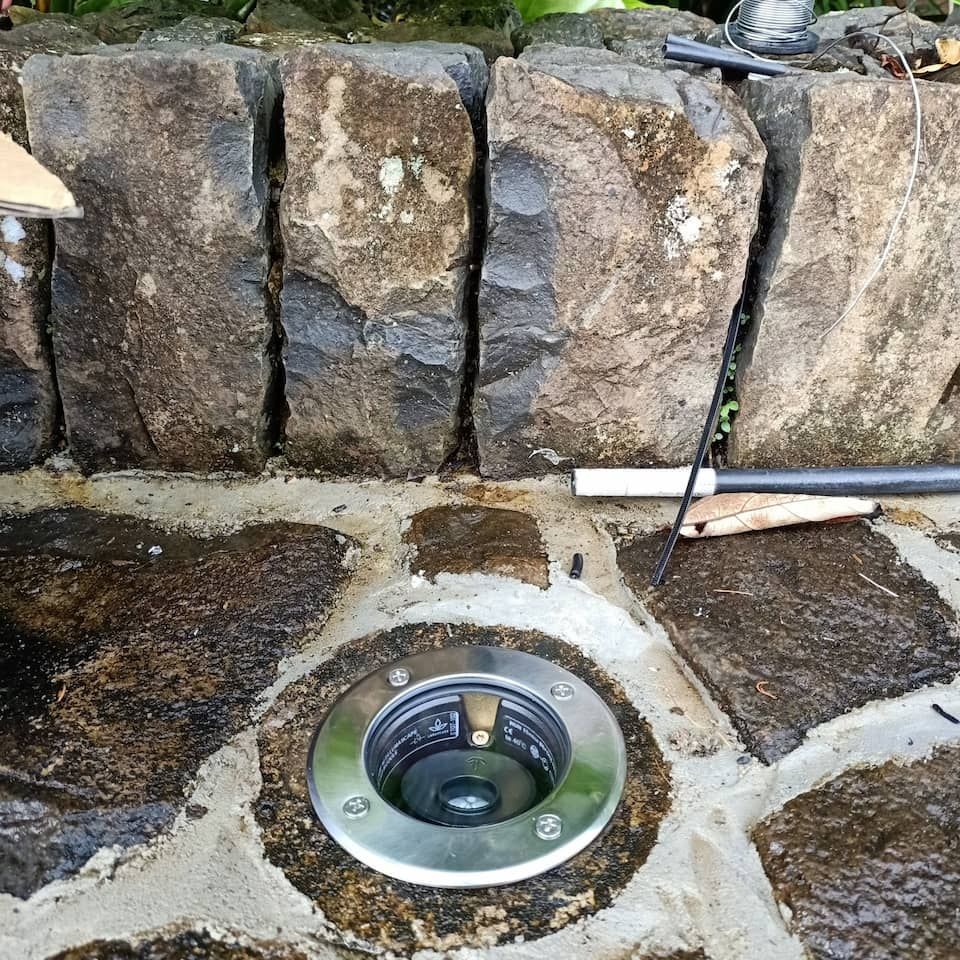 A Hole in a Stone Wall With a Light in It — Bangalow Electrical in Bangalow, NSW